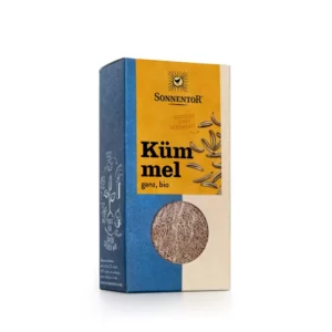 Eine Packung SONNENTOR KÜMMEL GANZ verfügt über ein blau-gelbes Design mit einem transparenten Fenster in der unteren Hälfte, durch das Bio-Kümmel präsentiert wird.