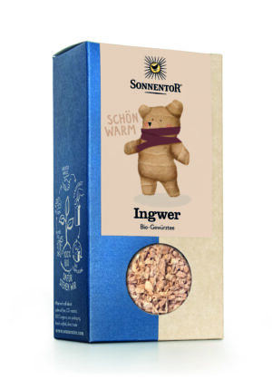 Schachtel SONNENTOR INGWER TEE LOSE mit Teddybär-Motiv. Blau-beige Verpackung mit transparentem Fenster, durch das der Bio-Ingwer-Tee im Inneren sichtbar ist.