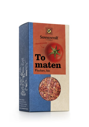 Schachtel SONNENTOR TOMATEN FLOCKEN, mit Tomatenmotiv und dem Text „Paradeisisch!“ auf der Verpackung.
