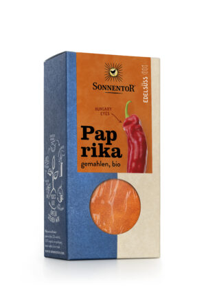 Schachtel SONNENTOR PAPRIKA EDELSÜSS mit der Aufschrift „Ungarn-Augen“, mit einem Bild einer roten Paprika und einem Fenster, durch das die Paprika im Inneren sichtbar ist.
