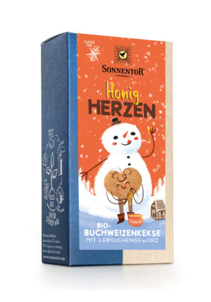 Unter dem neuen Produktnamen SONNENTOR KEKSE BIO SCHOKOPARADE erscheinen die Bio-Buchweizenkekse „Honig Herzen“ von Sonnentor in einer farbenfrohen Verpackung mit fröhlichem Schneemann, Keksherz und winterlichen Illustrationen.