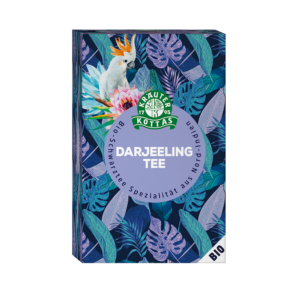 Schachtel KOTTAS TEE DARJEELING mit einem Design aus tropischen Blättern und einem Kakadu.