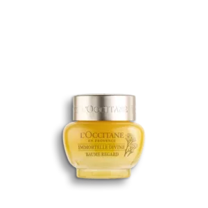 Ein Tiegel Immortelle Précieuse Augenbalsam von LOccitane mit goldenem Deckel und gelbem Glasbehälter.
