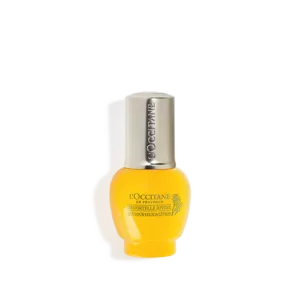 Gelbe Flasche LOccitane Immortelle Divine Augen-Lippenserum mit silberner Kappe, aufrecht stehend.