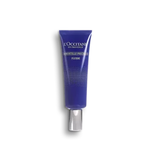 Eine blaue Tube LOccitane IMMORTELLE PRECIEUSE FLUID mit weißer Kappe auf schlichtem Hintergrund.