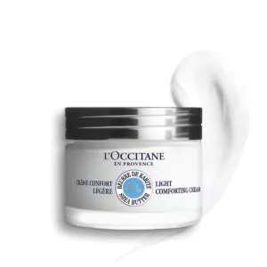 Ein Glas SHEABUTTER GESICHTSCREME LEICHT von LOccitane, daneben ein Sahneklecks.