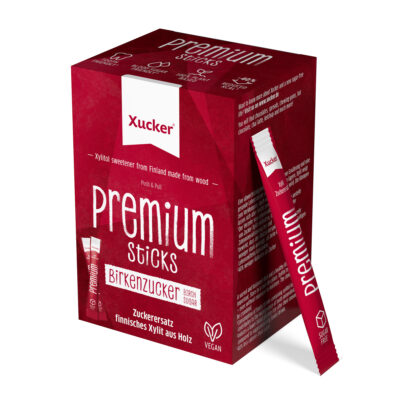 Rote Schachtel XUCKER PREM STICKS 10203 Birkenzucker (Xylit) Süßstoff, vegan, mit einer Stick Packung neben der Schachtel. Rote Schachtel XUCKER PREM STICKS 10203 Birkenzucker (Xylit) Süßstoff, vegan, mit einer Stick Packung neben der Schachtel.