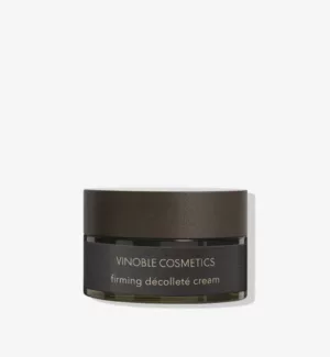 Abgebildet ist ein Tiegel mit straffender Dekolletécreme von Vinoble Cosmetics mit dunkelbraunem Deckel und Etikett vor schlichtem hellem Hintergrund.