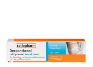 Eine 35-g-Box DEXPANTHENOL RTP WUNDCR von Ratiopharm hat ein orange-weißes Design mit einem Bild zur Anwendung auf der Haut.