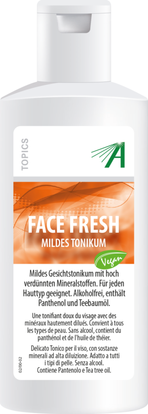 Bild einer Flasche mit der Aufschrift „SCHUESS FACE FRESH ADL“ mit Text in Deutsch und Italienisch, einem orange-weißen Design und einem grünen Vegan-Symbol.
