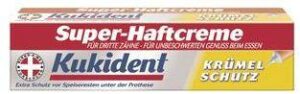 Schachtel KUKIDENT HAFTCR KRUEMELSCHUT Haftcreme für Zahnprothesen mit der Aufschrift „Super-Haftcreme“ und „Krümel Schutz“, versehen mit einem Kreuzsymbol in den Farben Rot, Weiß und Gelb.