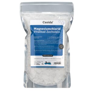 Beutel MAGN CHLORID VITALBD ZECHST, 1.000g, in weißen Flocken, versehen mit einem blau-schwarzen Etikett mit Produktdetails.