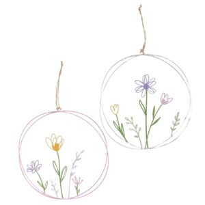 Zwei kreisförmige Hängeornamente mit Abbildungen von Blumen und Grünzeug, eines mit rosa Umriss, das andere mit weißem Umriss, die jeweils an einem Stück Schnur hängen.